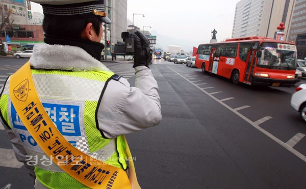 19일 서울 세종로 광화문 사거리에서 열린 교차로 준법질서 정착을 위한 캠페인에서 한 경찰 관계자가 캠코더로 교차로 꼬리물기 단속 장면을 연출하고 있다. 경찰청은 